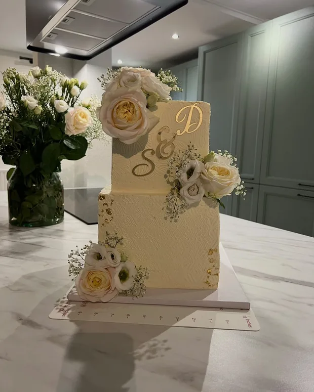 Ivory cake with a monogram and sugar flowers