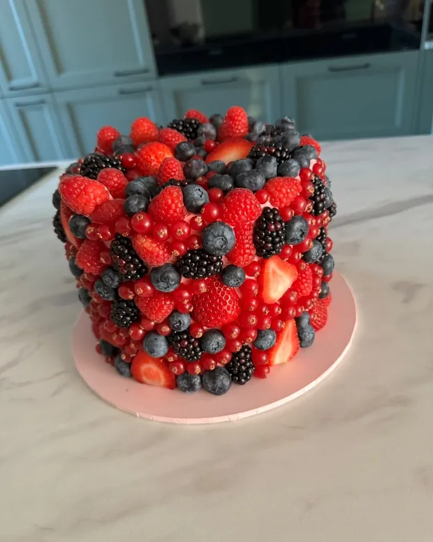 Cake covered all round with berries