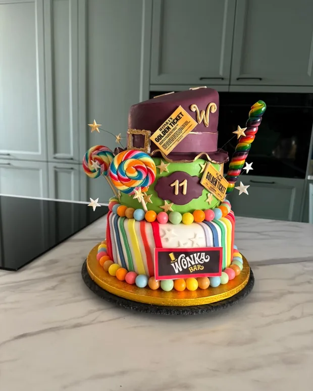Colourful cake with sweets and a golden ticket