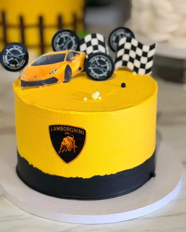 Yellow cake with a race car and a chequered flag