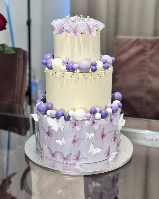 Three-tier cake with lilac butterflies
